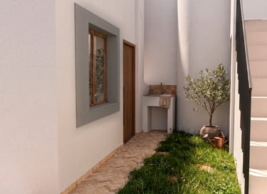 Minimalist Mediterranean patio with white walls, olive tree, and an outdoor stone sink.