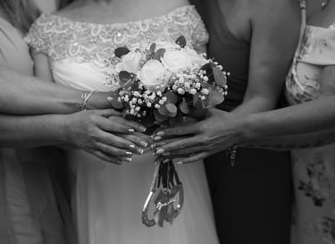 black and white image of bride and bridesmaids holding flowers
