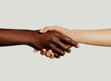 Close-up of a diverse handshake between two people symbolizing unity and partnership.