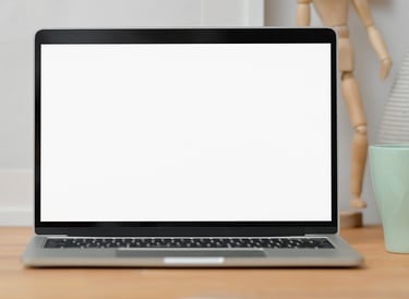 Laptop on desk with camera and mug
