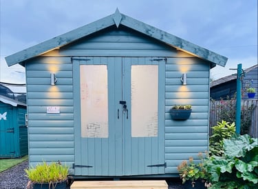 a small shed with a wooden shed and a garden