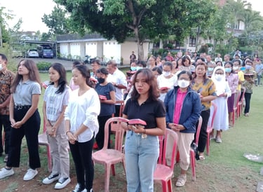 a group of people standing in a line of chairs