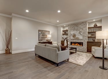 Newly finished basement with luxury vinyl flooring, recessed lighting and electric heat fireplace
