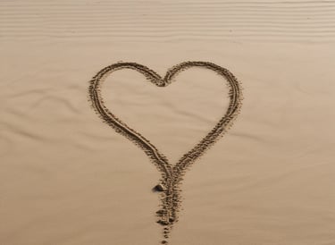 heart drawn on sand during daytime