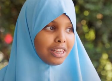 a young girl wearing a blue hijab hijab hijab hi