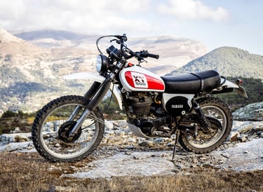 a Yamaha 500 XT parked on a rocky mountain side