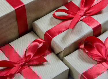 a bunch of gift boxes with red ribbons