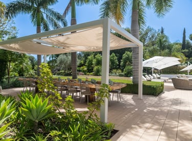 Spacious wooden dining table in the outdoor dining area of Villa Serenity