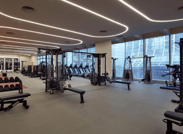 a gym with a lot of equipment and a bench