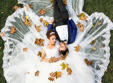 Wedding Photography - a bride and groom laying on the grass