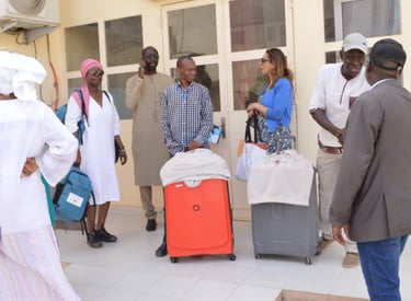 a group of people standing around a group of luggage