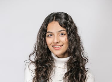 a woman with long hair and a white sweater
