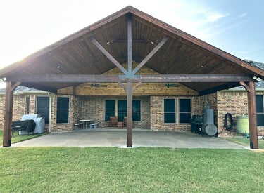 Larged covered patio with a vaulted wooden ceiling.
