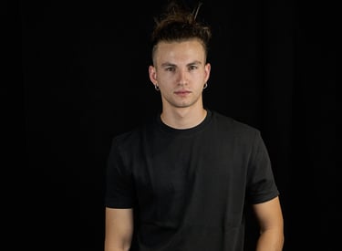 a man in a black shirt and white sneakers