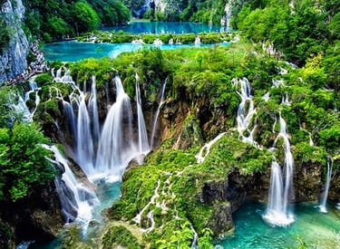 The photo shows amazing nature - a 3 turquoise blue lakes and the amazing waterfalls flowing between them,and greenery around