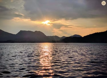 Warm golden reflections shimmering across Fateh Sagar udaipur during sunset.
