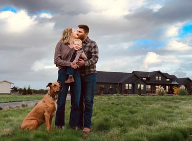 a family and dog standing in front of a house