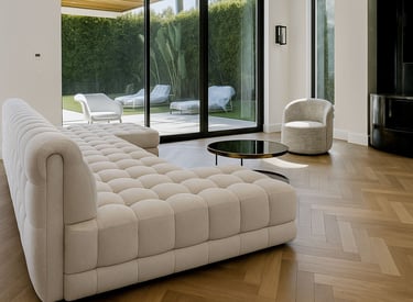 Modern living room with tufted beige sofa, round coffee table, and large glass doors to patio