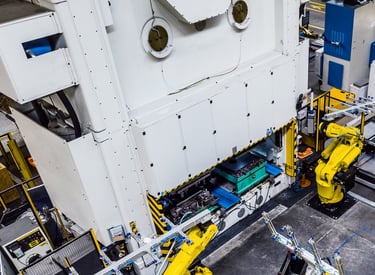 a factory with robots tending a press