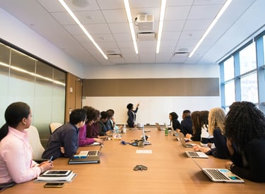 Attendees listen to a speaker during a leadership development presentation.
