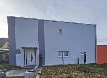 a man standing in front of a building with a man standing in front of it