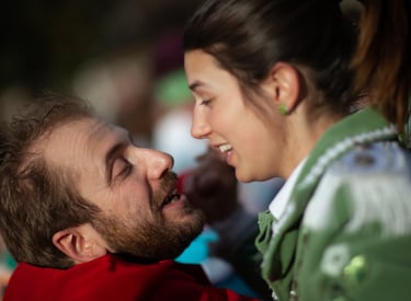 a man and woman are smiling and looking at each other