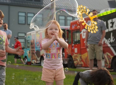 Little girl claps at the bubbles