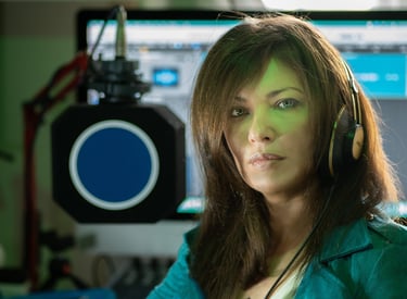 a woman in a green jacket and headphones
