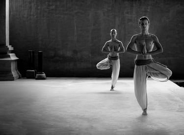 two people are doing yoga exercises on a platform