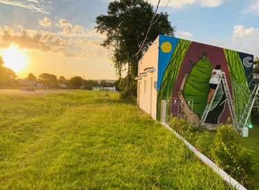 a mural of a woman in a colorful mural of a woman on a ladder