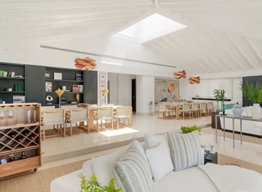 Spacious open-plan dining and lounge area with skylight at Villa El Olivo, Marbella