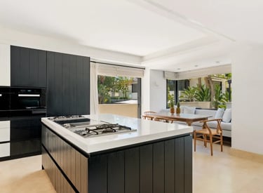 Bright kitchen with garden views and dining area at Villa El Olivo, Marbella