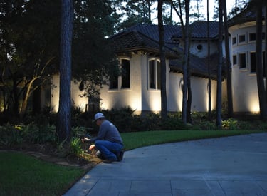 lighting technician servicing a path light fixture