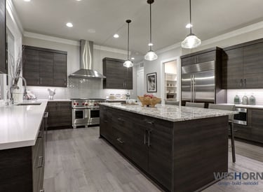 Sleek kitchen featuring dark wood cabinets and stainless steel appliances.
