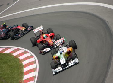 Three Formula 1 cars in turn 2 of the Canadian Grand Prix in 2012
