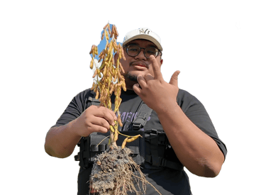 a man in a black shirt holding a plant with a plant in it