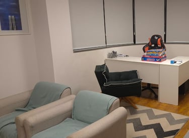 a desk with a desk and chairs in a room
