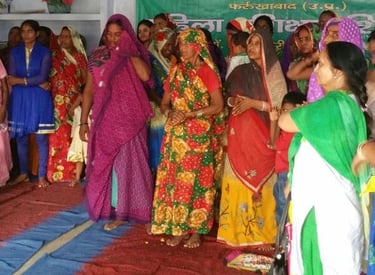 a group of women in colorful saree standing