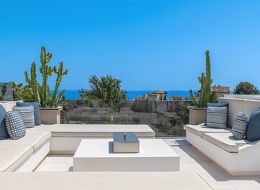 Rooftop lounge area with panoramic sea views at Villa Serenity