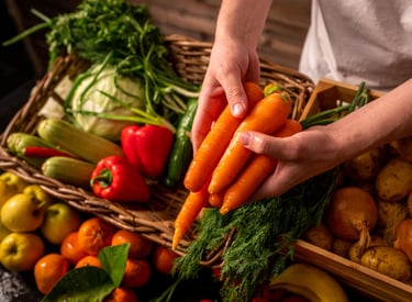 a person holding a bunch of carrots in a basket