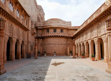 Beautiful red sandstone courtyard of Umaid Bhawan Palace in Jodhpur showcasing royal Rajasthani architecture.
