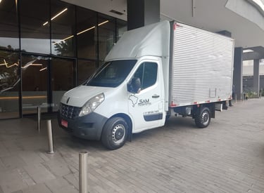 a truck with a white truck parked in front of a building