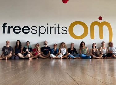 a group of yogis sitting on a wooden floor