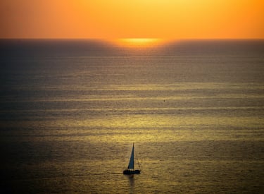 Boat sailing during a Greek sunset