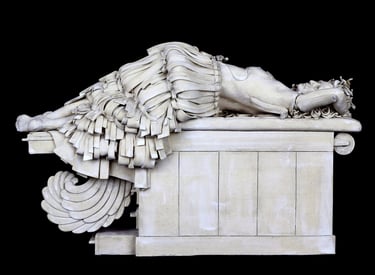 Ceramic sculpture of woman with feathered tail on examination table after breast reconstruction.