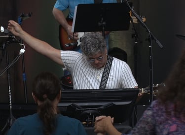 a man playing a keyboard and a woman singing