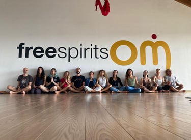 a group of yogis sitting on a wooden floor