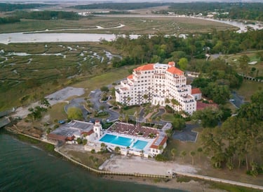 real estate drone photography of a condo complex on a river