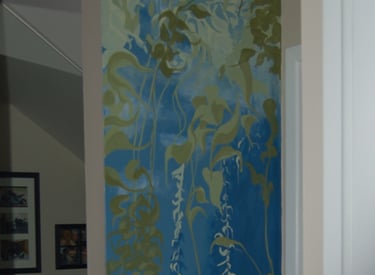 A narrow tall interior wall mural of a swaying peaceful kelp forest in greens and blues by Kathy LaFollett.