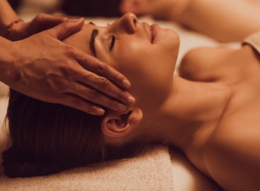Woman enjoying soothing facial and head massage at luxury wellness spa for deep relaxation